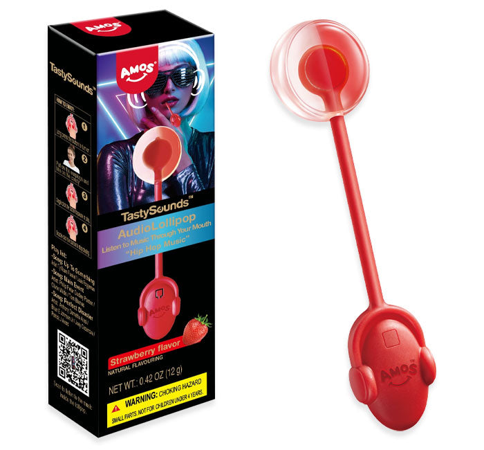 Amos TastySounds Strawberry AudioLollipop box next to the red headphone-shaped lollipop, showing the clear domed candy head and strawberry flavor label, net weight 0.42 oz.