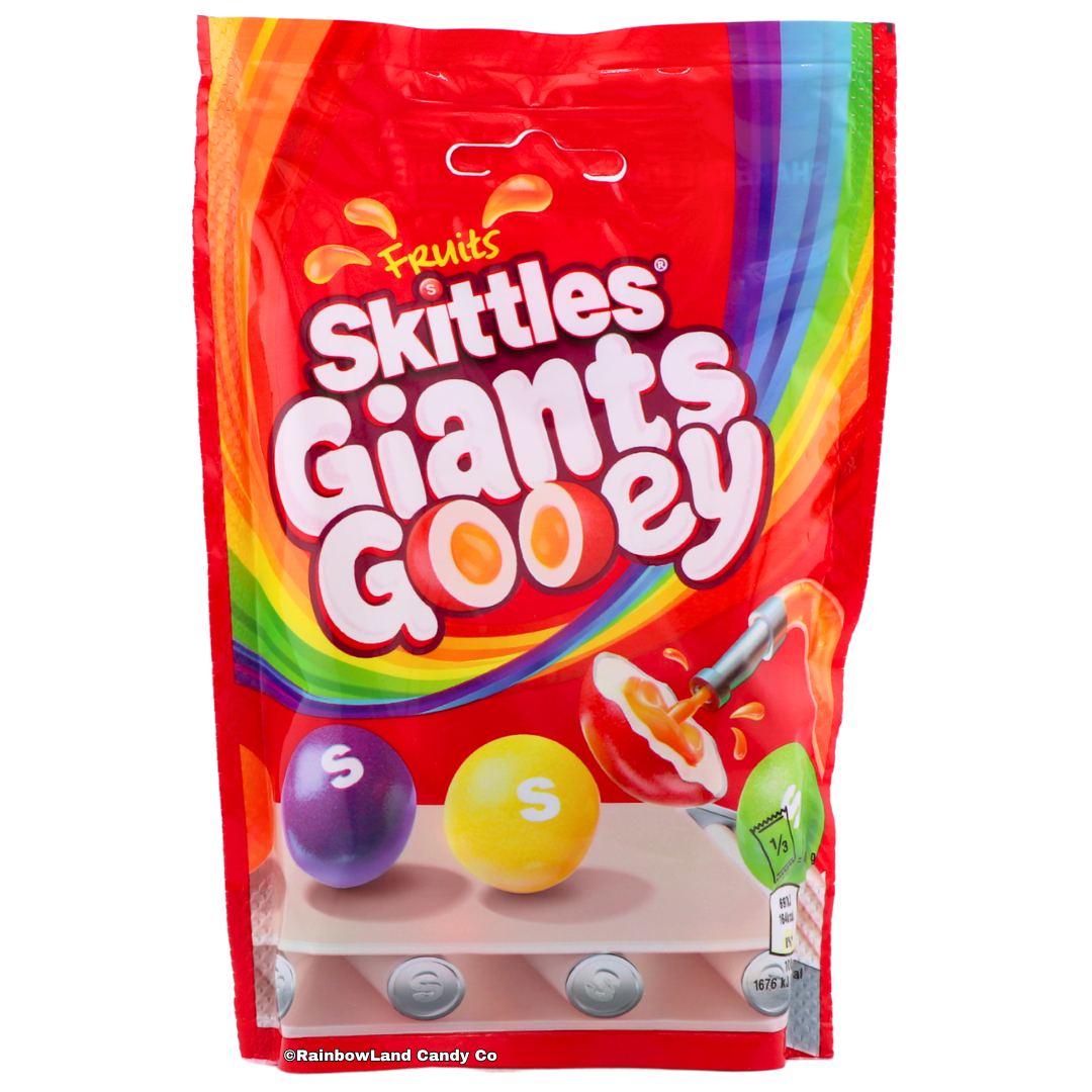 Red 125g bag of Skittles Giants Gooey featuring oversized purple and yellow Skittles with a crunchy shell and gooey fruity center, imported from the UK.