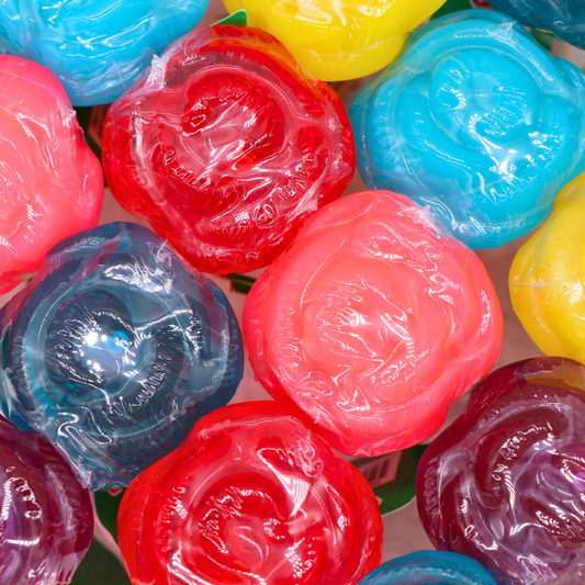 Colorful rose-shaped lollipops in assorted colors, detailed and wrapped.