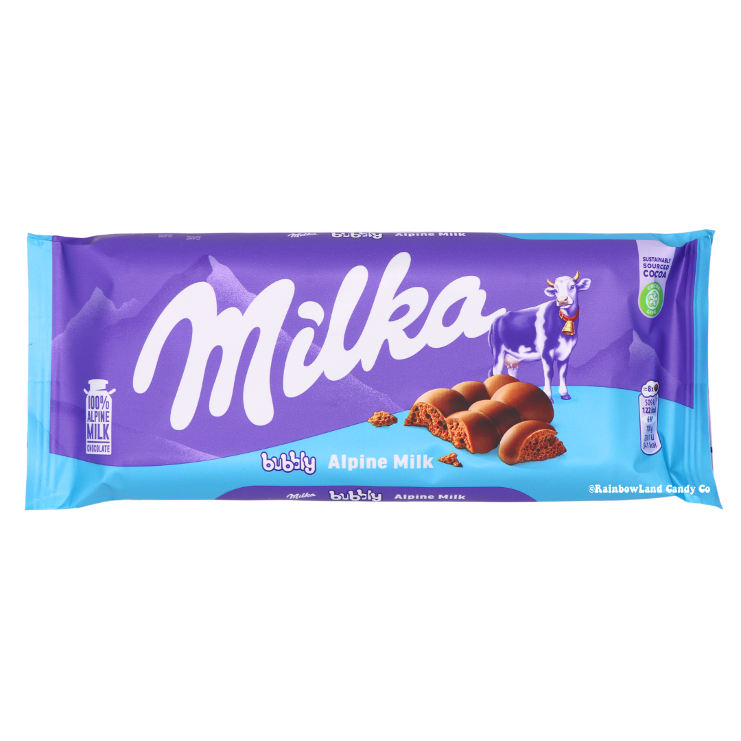 Milka Bubbly Alpine Milk Chocolate Bar wrapper, purple and blue packaging with the Milka logo, a cow illustration, and visible bubbly chocolate pieces, net weight 3.17 oz.