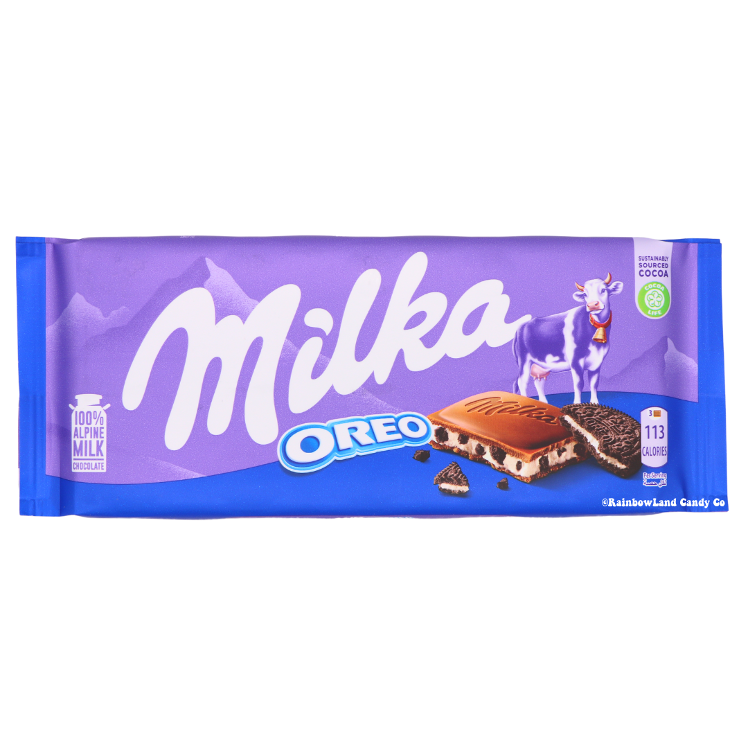 Milka Oreo Chocolate Bar wrapper, light purple and blue packaging with the Milka logo, cow illustration, and Oreo logo, showing a chocolate square with visible cream filling and cookie pieces, net weight 3.52 oz.