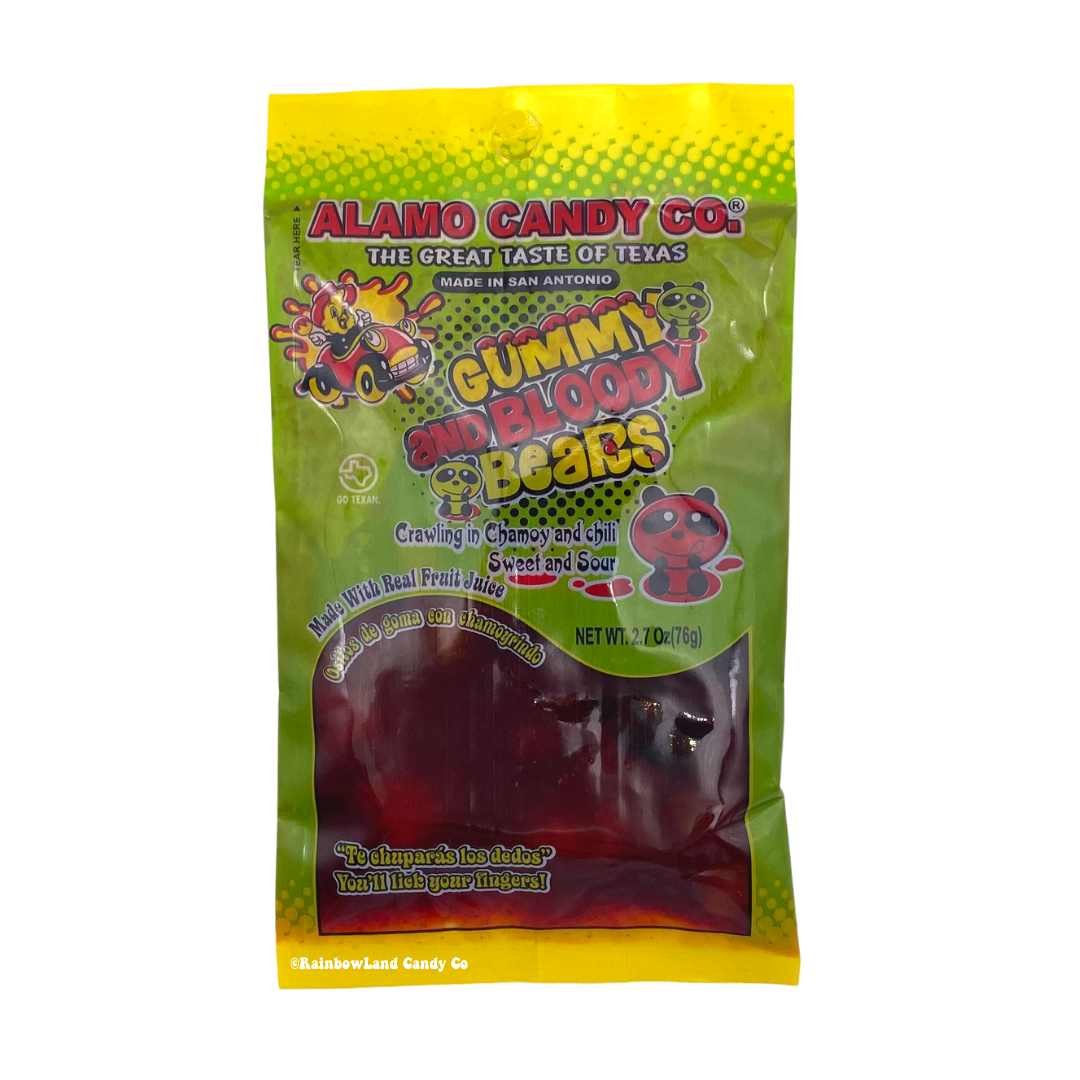 Alamo Candy Co. Gummy and Bloody Bears bag, yellow and green packaging with cartoon bear mascots, "Gummy Bears in Chamoy" and "Crawling in Chamoy and Chili, Sweet and Sour" text, dark red gummy bears visible through the window, net weight 2.7 oz (76g).