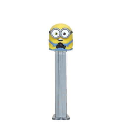A Minions-themed Pez dispenser featuring a yellow character head with goggles and a blue collar on a silver metal body, isolated on a white background.