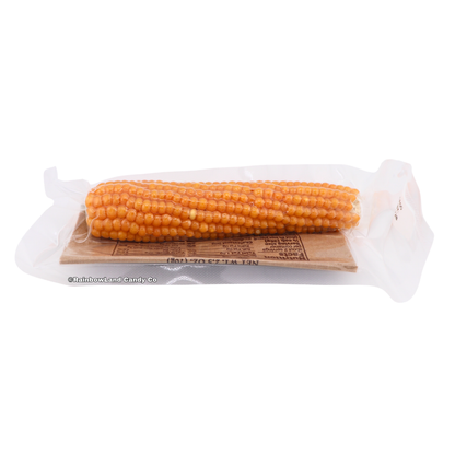 Farmer's Popcorn Cob package showing a corn cob visible through clear plastic wrap resting on a kraft paper backing, net weight 2.5 oz (70g).