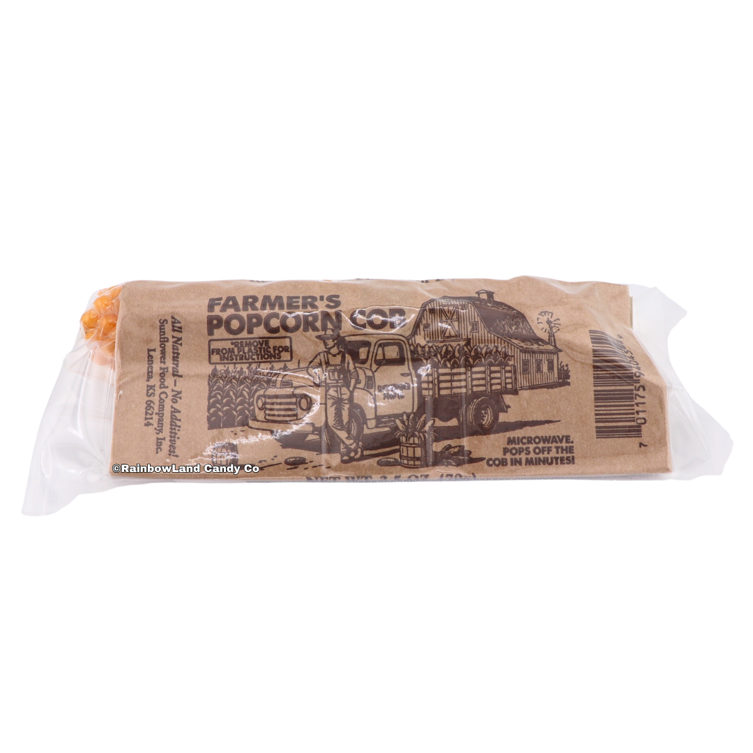 Farmer's Popcorn Cob package showing the kraft paper design with a farmer, vintage truck, and barn illustration, along with "Microwave, Pops Off the Cob in Minutes!" instructions.
