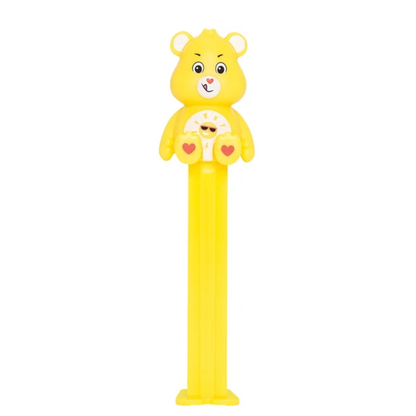 Yellow Funshine Bear PEZ dispenser with a smiling sun-and-sunglasses belly badge, heart-shaped nose, and yellow candy stem.