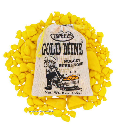 A 2 oz Gold Mine Nugget Bubble Gum burlap pouch with a prospector illustration resting on top of a scattered pile of yellow gold nugget-shaped banana bubble gum pieces.