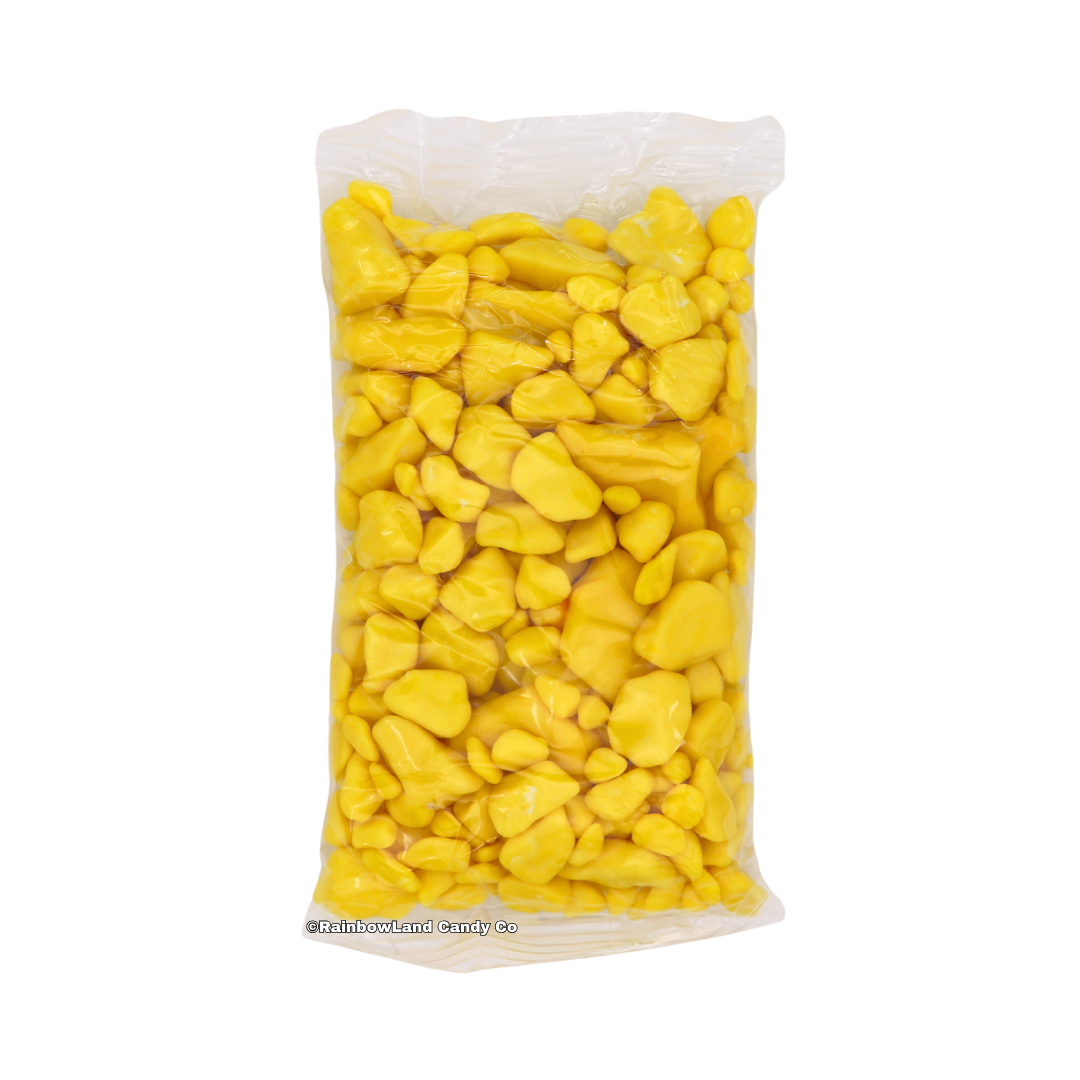Yellow gold nugget-shaped banana bubble gum pieces packed inside a clear plastic bag, shown standing upright against a white background.
