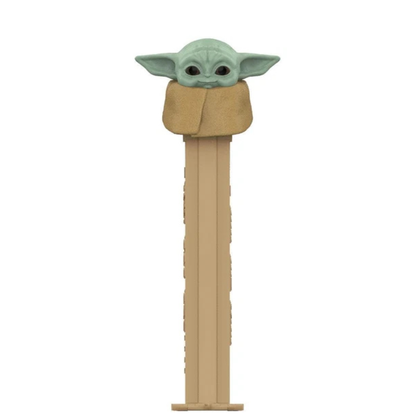 Grogu PEZ dispenser, green skin, large ears, wrapped in a tan blanket, tan dispenser.