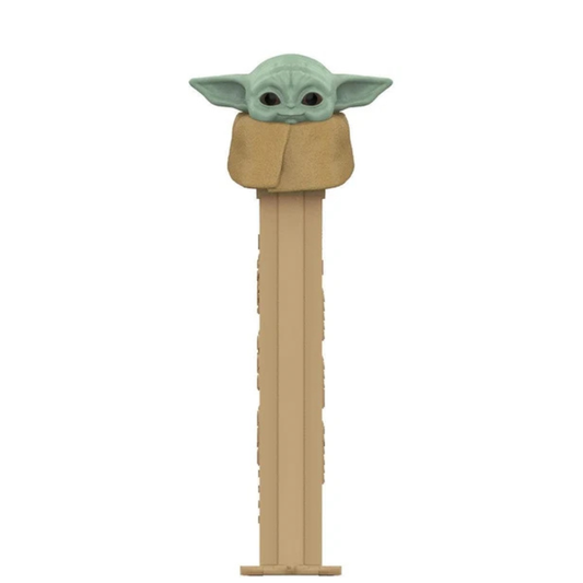 Grogu PEZ dispenser, green skin, large ears, wrapped in a tan blanket, tan dispenser.