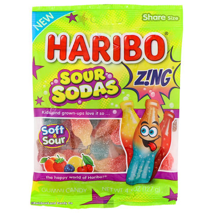 Green and purple Haribo Sour Sodas Zing share size candy bag featuring gummy soda bottle shapes in Lemon-Strawberry, Peach-Blue Raspberry, and Cherry-Cola flavors, labeled Soft & Sour, net weight 4.5 oz (127 g).