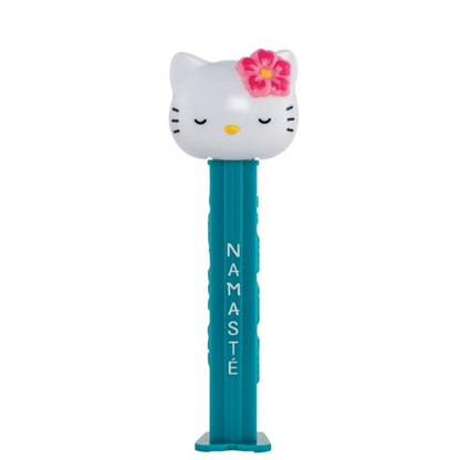 Hello Kitty & Friends PEZ dispenser featuring Hello Kitty with a pink flower and closed eyes, teal dispenser with white "Namasté" lettering, sold by RainbowLand Candy Co.