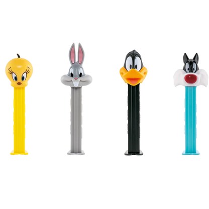 Four PEZ Looney Tunes dispensers lined up together — Tweety Bird on a yellow dispenser, Bugs Bunny on a gray dispenser, Daffy Duck on a black dispenser, and Sylvester the Cat on a teal dispenser.