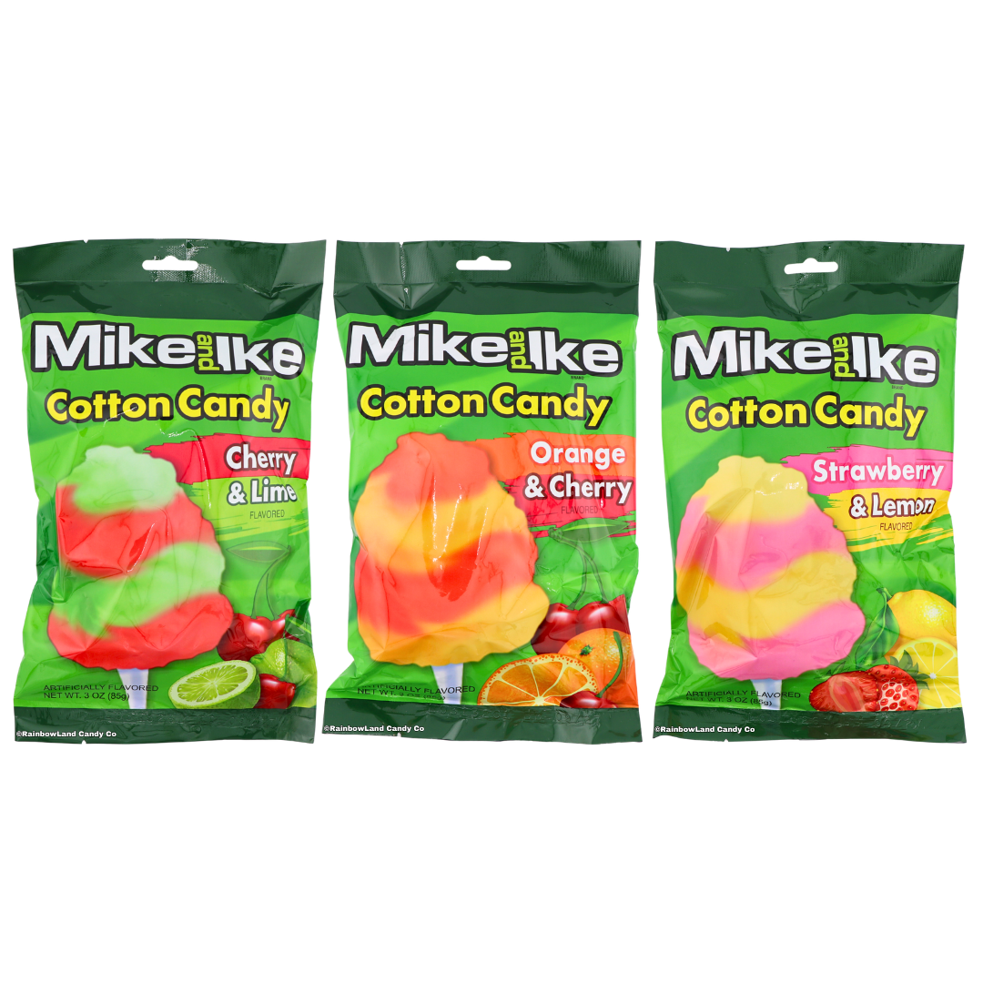 Three Mike and Ike Cotton Candy bags lined up together on a green pouch background, featuring Orange & Cherry, Strawberry & Lemon, and Cherry & Lime flavors, each with a swirled cotton candy pop graphic and matching fruit imagery.