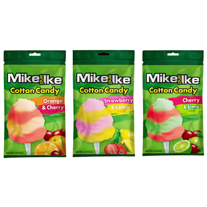 Three Mike and Ike Cotton Candy bags lined up together on a green pouch background, featuring Orange & Cherry, Strawberry & Lemon, and Cherry & Lime flavors, each with a swirled cotton candy pop graphic and matching fruit imagery.