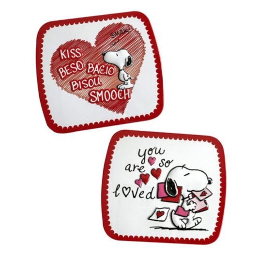 Peanuts Snoopy Valentine's Day candy tin designs, "Kiss" design with Snoopy inside a scribbled red heart and the word "kiss" in multiple languages, and "You Are So Loved" design with Snoopy reading valentines.