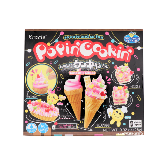 Black Kracie Popin' Cookin' Cake DIY candy kit box featuring a pink swirled soft serve cone, a topped ice cream cone, a candy tart, and two layered pink mini cakes.