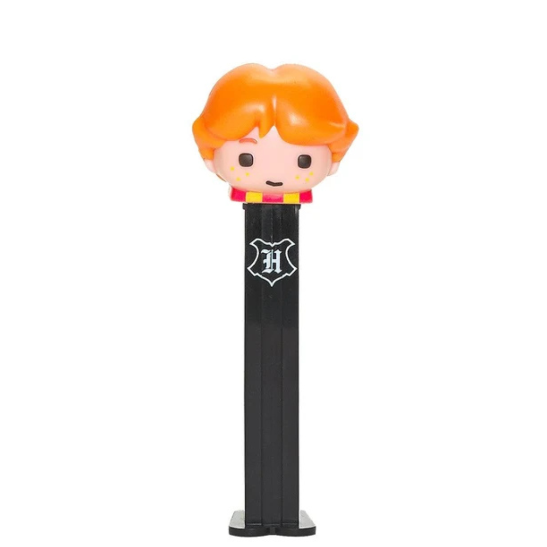 Ron Weasley PEZ dispenser from Harry Potter, orange tousled hair, freckled face, red and yellow house scarf, black dispenser with Hogwarts crest.