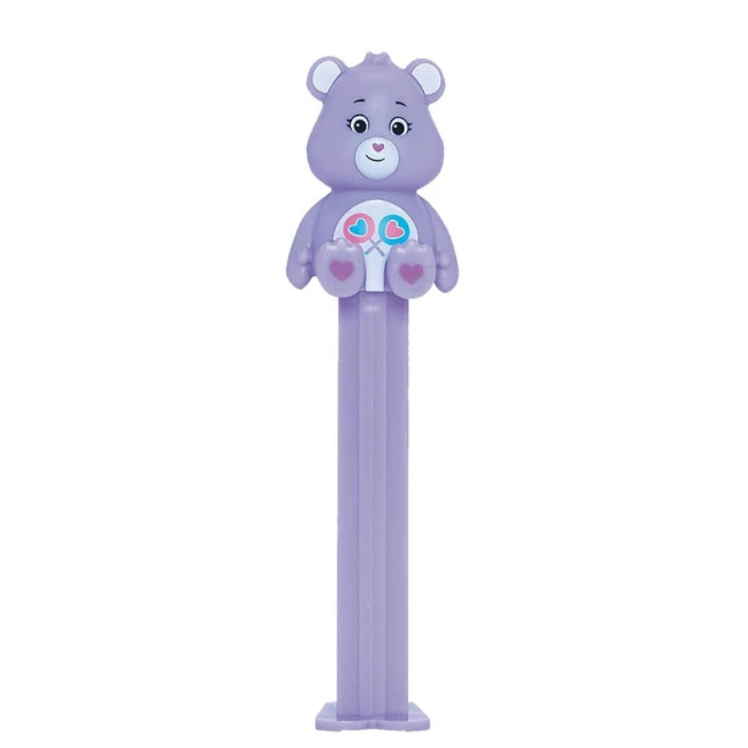 Purple Share Bear PEZ dispenser with two heart-shaped lollipops on its belly badge, heart-shaped nose, and purple candy stem.