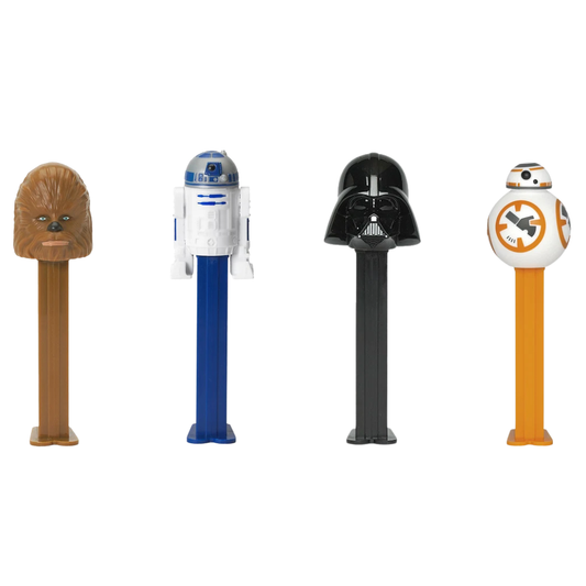 Four PEZ Star Wars dispensers lined up together — Chewbacca with brown shaggy fur, R2-D2 in blue and white astromech design, Darth Vader with a black helmet, and BB-8 in orange and white.