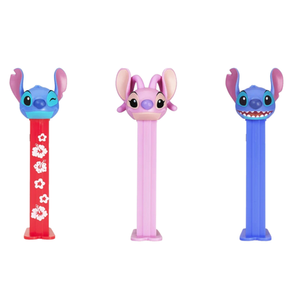 Three PEZ Stitch dispensers lined up together — winking Stitch on a red hibiscus-patterned dispenser, Angel with pink ears on a pink dispenser, and smiling Stitch on a blue dispenser.