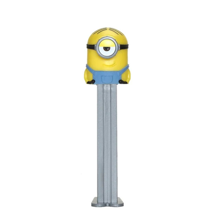 A Minions-themed Pez dispenser featuring a yellow character head with one eye and a blue over-ear headphone design on the body, set against a plain white background.