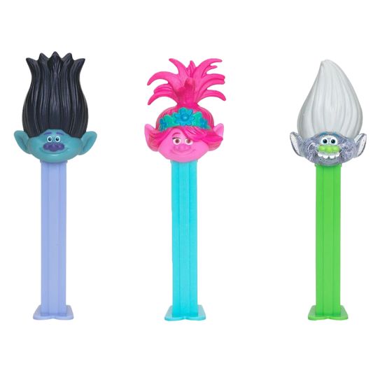 Three PEZ Trolls dispensers lined up together — Branch with spiky black hair, Queen Poppy with tufted pink hair, and Guy Diamond with sparkly gray hair, each on a matching colored dispenser.
