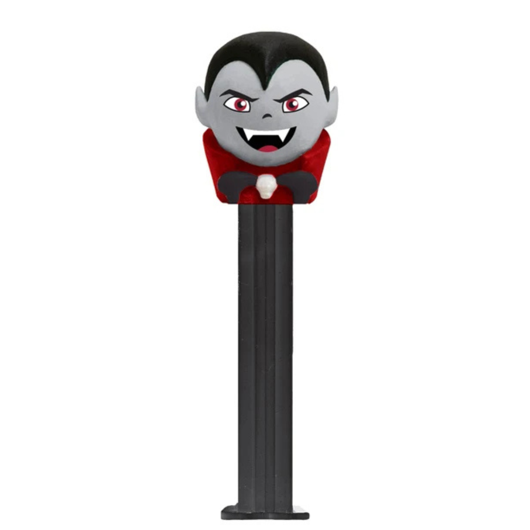 Halloween PEZ dispenser featuring a vampire with black hair, red cape, and fangs, black dispenser, sold by RainbowLand Candy Co.