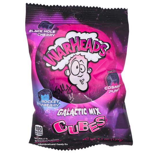 Warheads Galactic Mix Cubes, 4.5 oz bag in purple and black space-themed packaging with cube-shaped sour candy and Black Hole Cherry, Rocket Raspberry, and Cosmic Punch flavor callouts on the front.