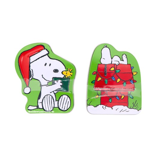 Green Snoopy Christmas candy tin showing Snoopy in a red Santa hat, sitting and holding out a green treat toward Woodstock, who is perched nearby. Green Snoopy Christmas candy tin showing Snoopy lying on top of his red doghouse, which is wrapped in colorful string lights and set in the snow.