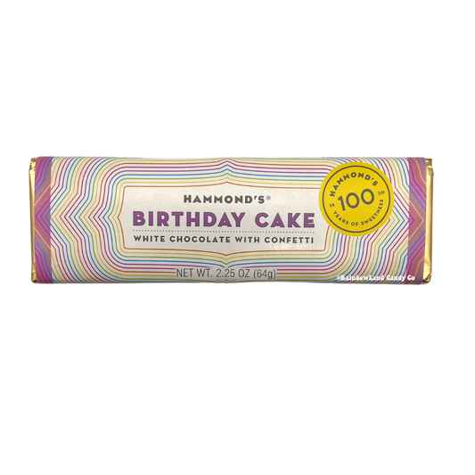 Hammond's Birthday Cake White Chocolate Bar, 2.25 oz, showing a colorful rainbow-striped wrapper with Hammond's branding, "White Chocolate with Confetti" labeling, and a gold 100-year anniversary badge.